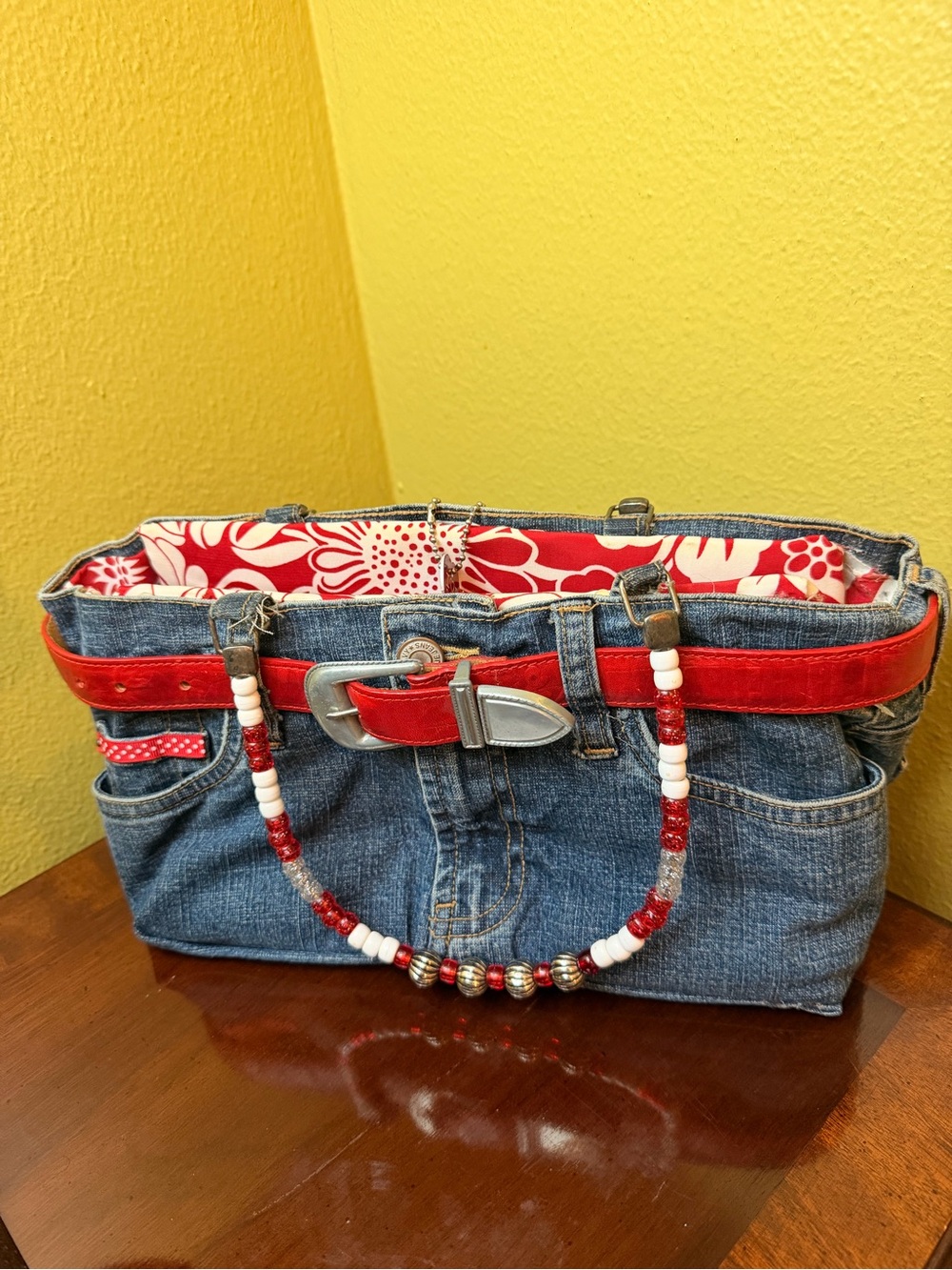 Stylish Denim Handbag with Red Trim and Beaded Handle